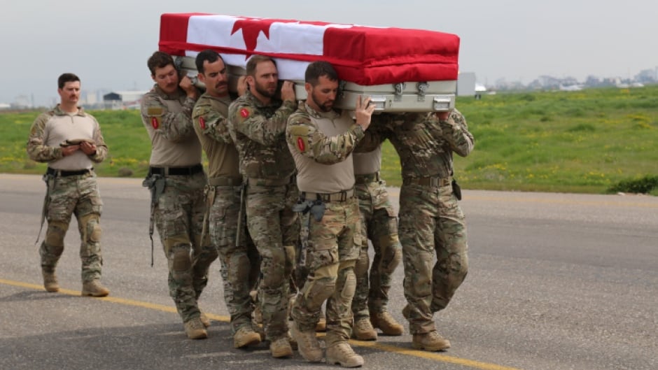 Pallbearers from the Canadian Special Operations Regiment (CSOR) carry the casket of their fallen comrade, Sgt. Andrew Joseph Doiron, during the ramp ceremony at the Erbil International Airport in Iraq on Sunday.