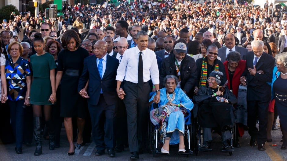 Congressman John Lewis walks with President Barack Obama, his family and Amelia Boynton Robinson, who was beaten during "Bloody Sunday" in the original march on Selma, Ala., 50 years ago.