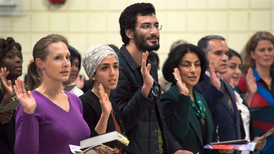 New Canadians take the oath of citizenship at a ceremony in Dartmouth. The dramatic drop in citizenship rates noted as Canada changes citizenship test has some wondering if its unintended consequence or foreseeable fallout?