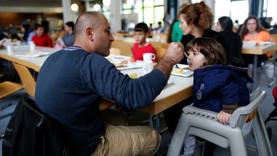 A Syrian refugee family eats at the 'Friedland' refugee camp in the central German village of Friedland.