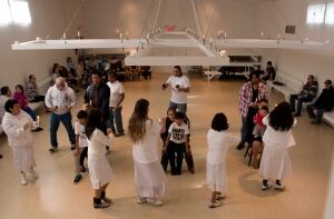 Shaker members circle three children