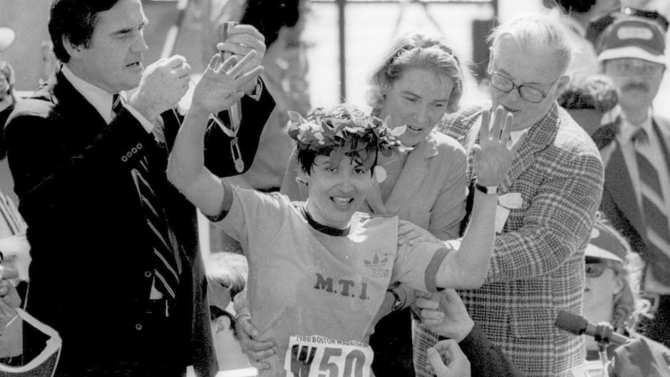 In this April 22, 1980, file photo, Rosie Ruiz, waves to the crowd, after she was announced winner of the women's division of the Boston Marathon. Ruiz pretended to win by coming out of the crowd about one mile before the finish line. (AP Photo/File)