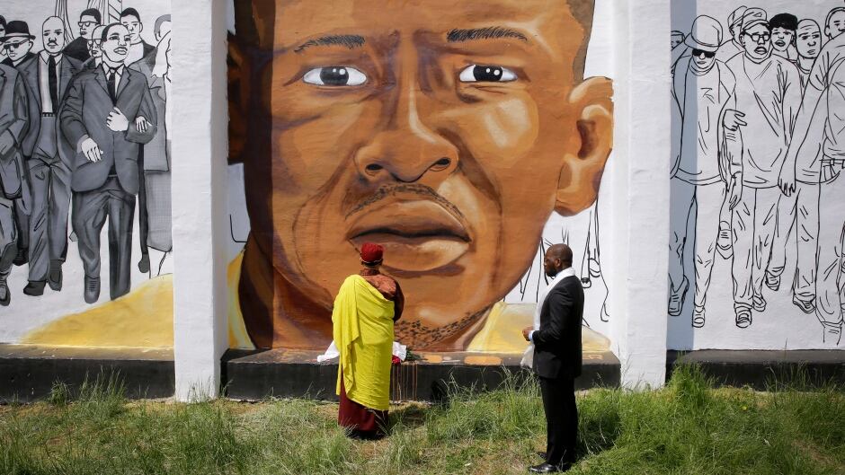 Faith and community leaders in Baltimore view a mural of Freddie Gray on May 7, 2015.