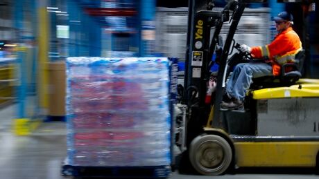 A worker operates a forklift at the Nestle Waters Canada plant near Guelph, Ontario, Canada, on Friday, Jan. 16, 2015. Nestle, the world's largest food company, owns about 60 water brands including Pure Life, the world's best-selling label. Photographer: Kevin Van Paassen/Bloomberg Nestle bottled water factory guelph jobs