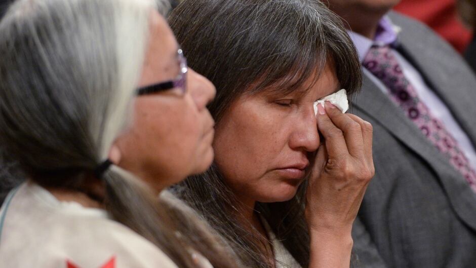 A woman wipes a tear during the closing ceremony of the Indian Residential Schools Truth and Reconciliation Commission, at Rideau Hall in Ottawa on Wednesday, June 3, 2015. THE CANADIAN PRESS/Sean Kilpatrick