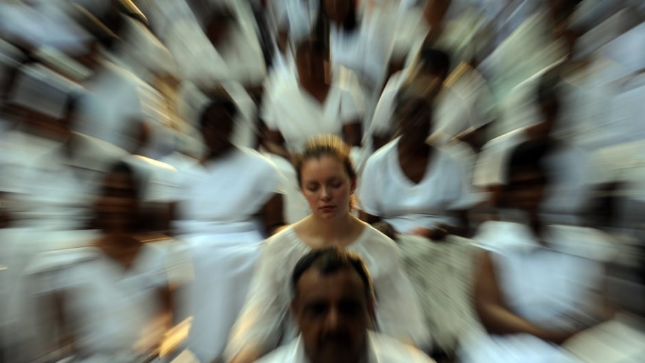 A foreign election observer (centre), together with Sri Lankan citizens, meditate during a special public meditation and prayer gathering organised for a peaceful election in Colombo on January 24, 2010.