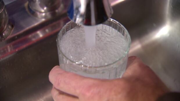 Drinking water out of a tap