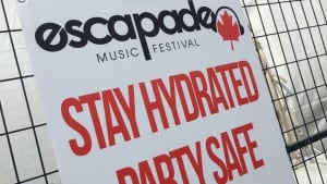 Escapade Music Festival sign: Stay Hydrated, Party Safe