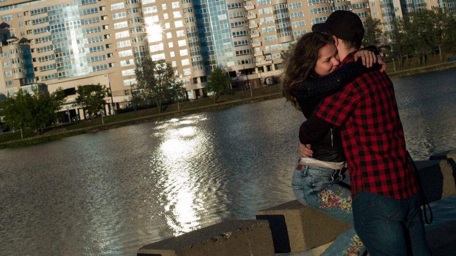 MINSK, BELARUS - JULY 04: A couple embrace next to the Svislach River at sunset on July 04, 2017 in Minsk, Belarus. The post-Soviet republic of Belarus, borders Poland to its West, Lithuania to its North West, Russia to its North East, and Ukraine to its South. A predominantly flat country of Lakes and Forests, home to Wolves, Brown Bears and EuropeĆs only population of Bison. The population is around 9.5 million people, and it often cited as being 'Europe's last Dictatorship'. Belarus' current President Alexander Lukashenko has been in power since 1994, winning his fifth term in October 2015 with 83.5 % of the vote. Visa restrictions to Belarus have recently been lifted, allowing citizens from the European Union, America and 51 other countries visa-free entry to the country for up to 5 days through Minsk International Airport. (Photo by Dan Kitwood/Getty Images)