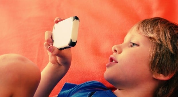 Child looks at mobile phone