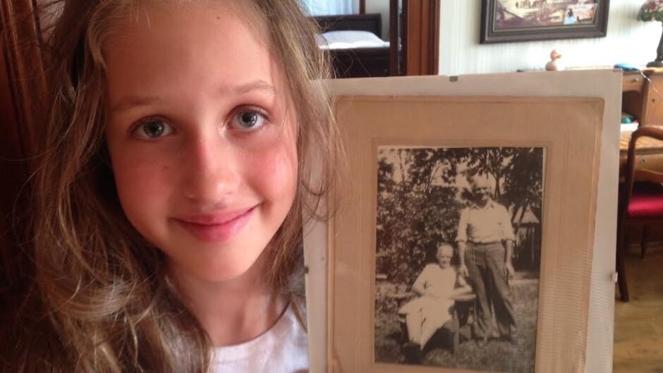 Laila Lynk Graham holding a photo of her great-grandparents, Dahabieh and Mahfouz Joseph (El-Rafieh).
