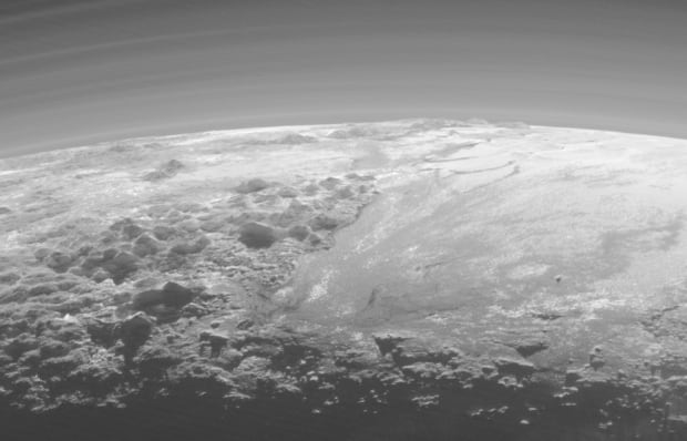 Pluto backlit mountains plains