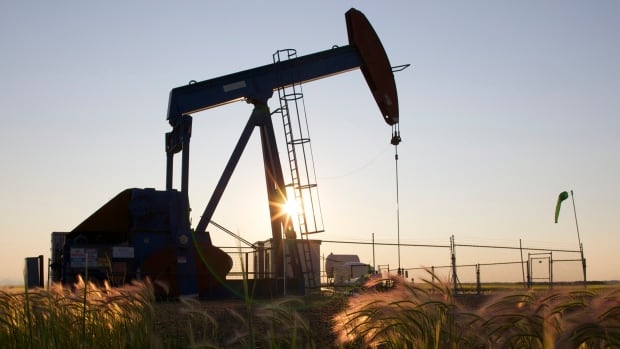 An oil pump jack pumps oil in a field near Calgary on July 21, 2014, when oil was trading about $100 per barrel. The province's economy has been battered as oil crashed over the ensuing two years, but should return to growth in 2017, says BMO.