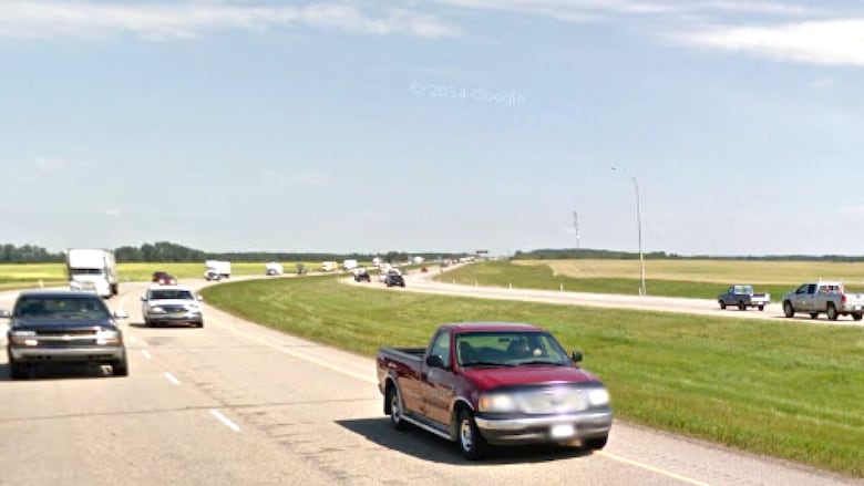 A view of Highway 2 surrounded by green grass 