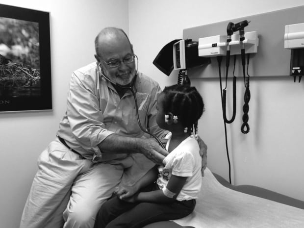 Paul Caulford looks after a child in the clinic.