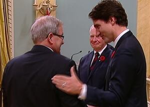 Justin Trudeau shakes Lawrence MacAualay's hand