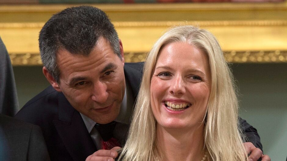 Hunter Tootoo, minister of fisheries, oceans, and the Canadian Coast Guard speaks with Catherine McKenna, minister of the environment and climate change after being sworn in. McKenna says the national target set by the Conservatives for cutting greenhouse gas emissions should be considered a floor for future action.
