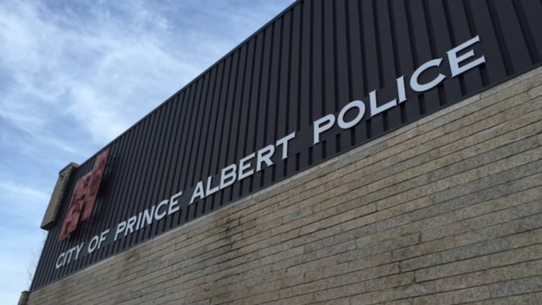 White letters are pinned to a brown brick building. They read, 'City of Prince Albert Police.'