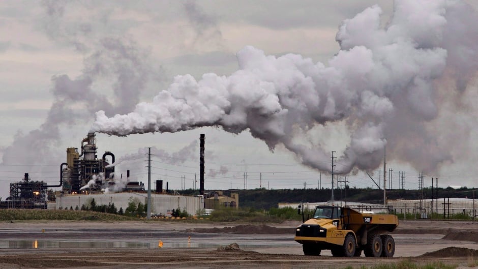 A dump truck works near the Syncrude oil sands extraction facility near the city of Fort McMurray, Alberta on Sunday June 1, 2014.