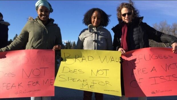 three women protest Brad Wall`s statement on Syrians