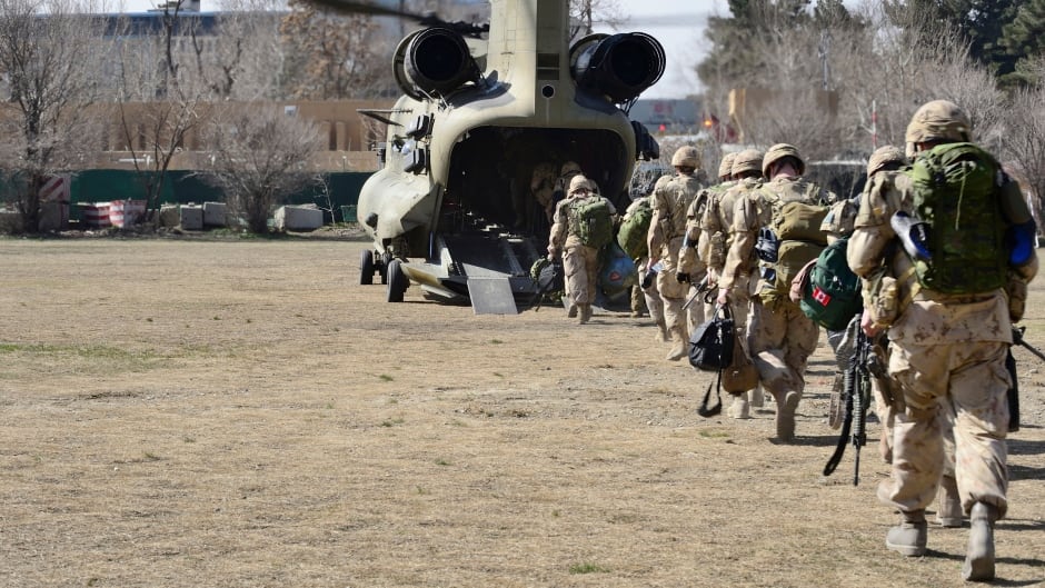 The last Canadians involved in the NATO training mission in Afghanistan board a U.S. Chinook helicopter as they leave the International Security Assistance Force (ISAF) headquarters in Kabul, Afghanistan March 12, 2014.