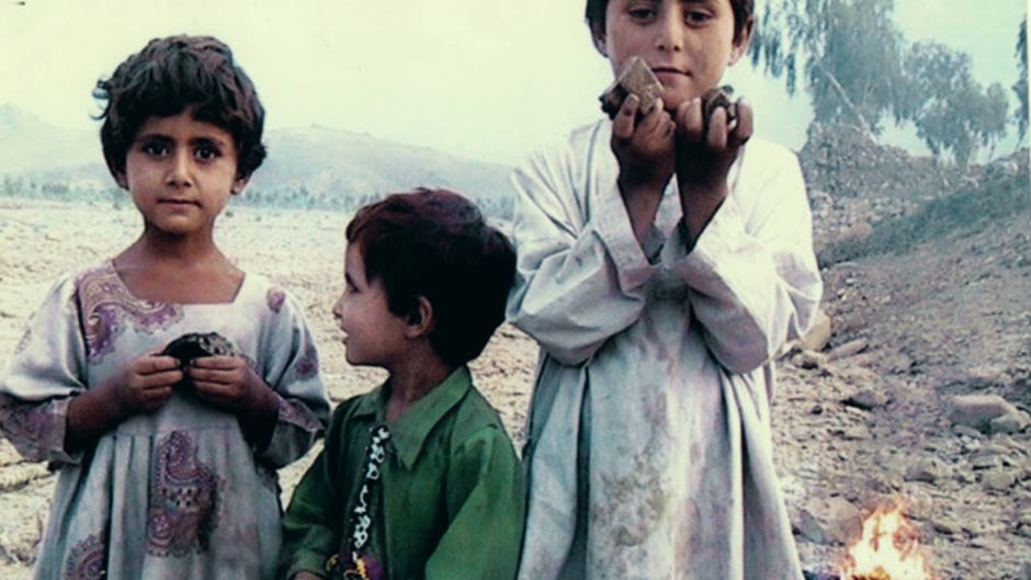 Three children stand amidst the rubble in the Dande Darpa Khel region of North Waziristan. They are holding remnants of a drone-fired missile and rubble from their neighbour's house. They don't yet understand their parents were killed in the strike. Jalaluddin Haqqani, an Afghan fighter and Taliban member who went on to found the Haqqani network, is said to have been the target.