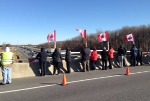 Crowd awaits vehicle carrying body of John Robert Gallagher