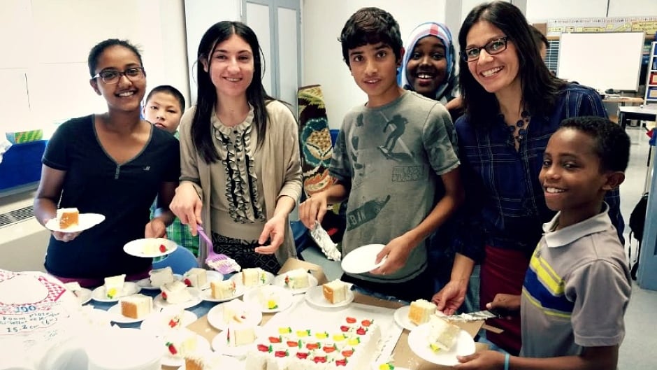 Winnipeg teacher Maranda Obradovic (second from right) from Hugh John Macdonald school in Winnipeg celebrating with kids from the literacy and academic learning centre. Researcher Jan Stewart says Hugh John Macdonald is an excellent example of a school that is doing a good job integrating refugees.