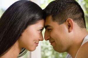 Man woman touching foreheads profile