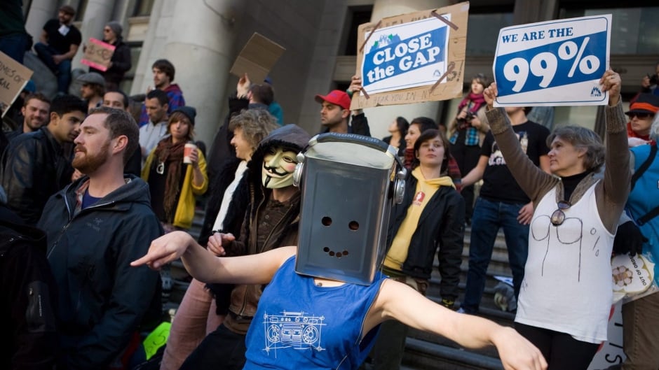 Protestors dance outside the Vancouver Art Gallery during the Occupy Vancouver group assembly in Vancouver.