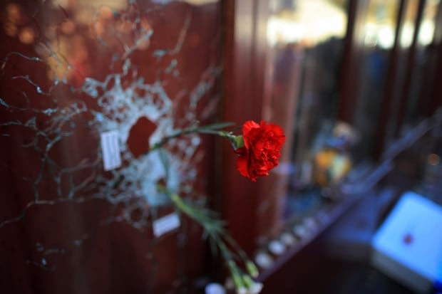 2015 pictures of the year Paris attacks rose in bullet hole Nov 15