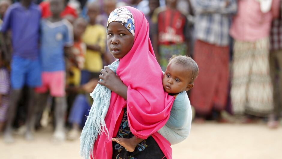 A Somali refugee child carries her sibling at the Ifo camp in Dadaab near the Kenya-Somalia border, May 8, 2015. Kenya's government threatened to close the Dadaab refugee camp, the world's biggest refugee camp was seen as a security risk. The United Nations refugee agency urged Kenya to reconsider an order to close the teeming Dadaab refugee camp, warning that sending Somali refugees back to their homeland would have "extreme humanitarian and practical consequences".