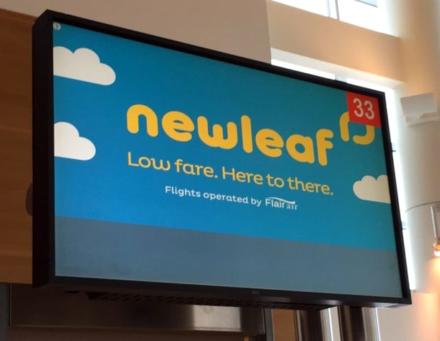 NewLeaf Travel Company sign at Winnipeg airport