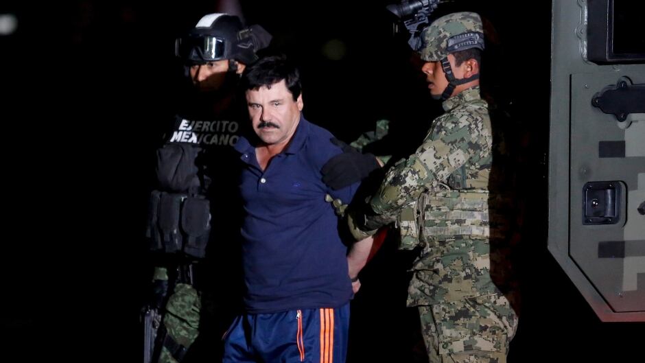Joaquin "El Chapo" Guzman is escorted by soldiers in Mexico City, January 8, 2016.