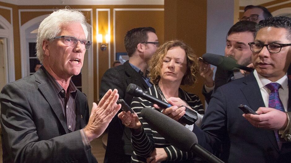 Natural Resources Minister Jim Carr talks with reporters on his way to a morning session at a cabinet retreat at the Algonquin Resort in St. Andrews, N.B. on Monday, Jan. 18, 2016. The federal Liberals are working on their plans for the year including their upcoming budget.
