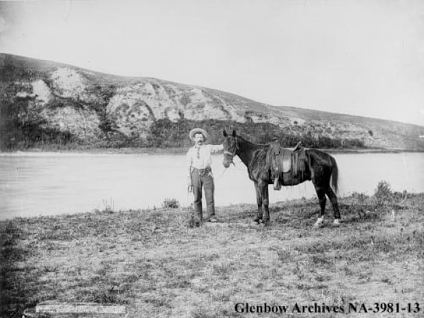 Man with his saddle horse, 1890