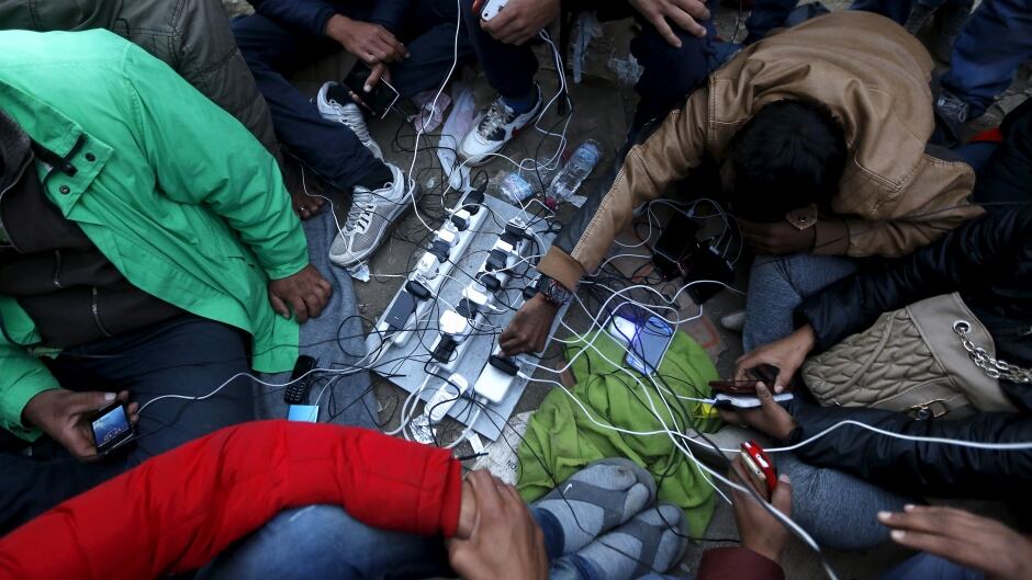 Stranded migrants charge their phones at the Greek-Macedonian border.