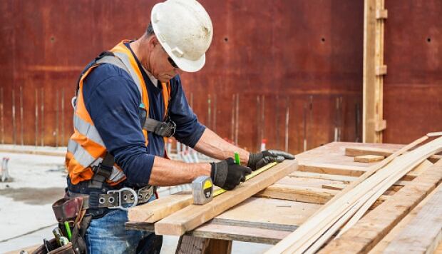 construction worker measuring