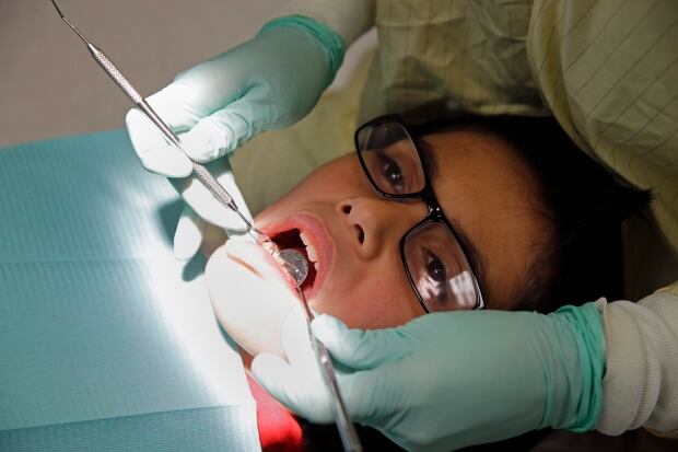 A youth undergoing dental work
