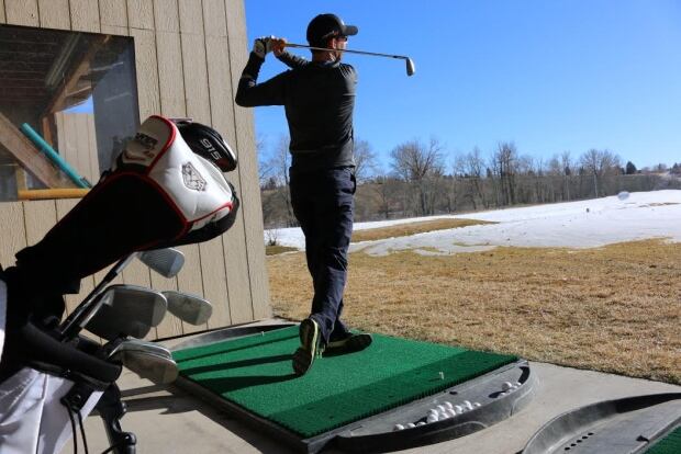 Golfer driving range warm weather