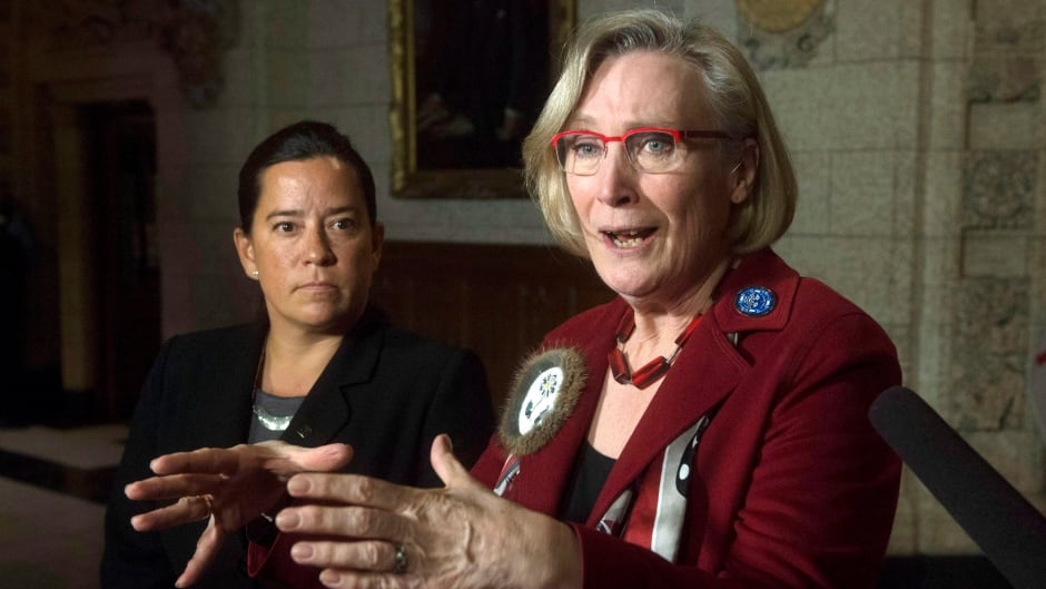Minister of Justice and Attorney General of Canada Jody Wilson-Raybould, left, looks on as Minister of Indigenous and Northern Affairs Carolyn Bennett speaks.