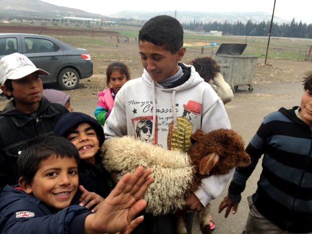 Syrian children living in Kilis Turkey gather with one of the go