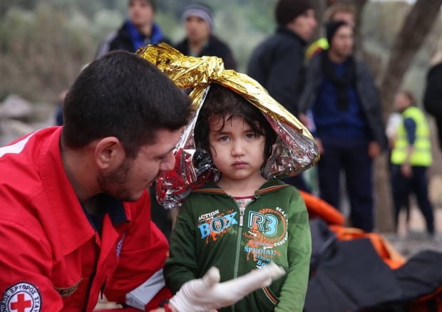 Refugee kid with Red Cross in Lesbos