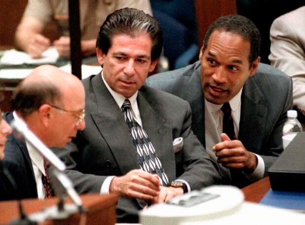 O.J. Simpson consulting with friend Robert Kardashian