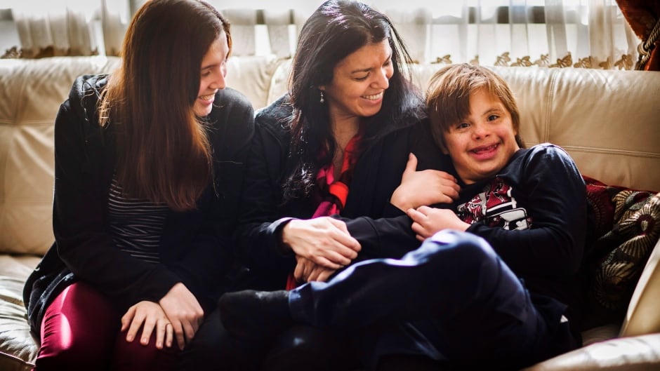 Nico Montoya, a 13-year-old boy with Down syndrome, with his mother Alejandra Garcia, centre, and his sister Tania at their home in Richmond Hill, Ont. The family was denied permanent Canadian residency arguing Down Syndrome would be a burden on taxpayers.