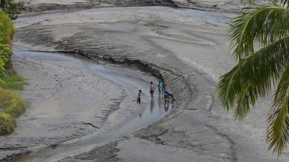 Children playing in tailings downstream from the Ok Tedi Mine in Papua New Guinea, 2009.