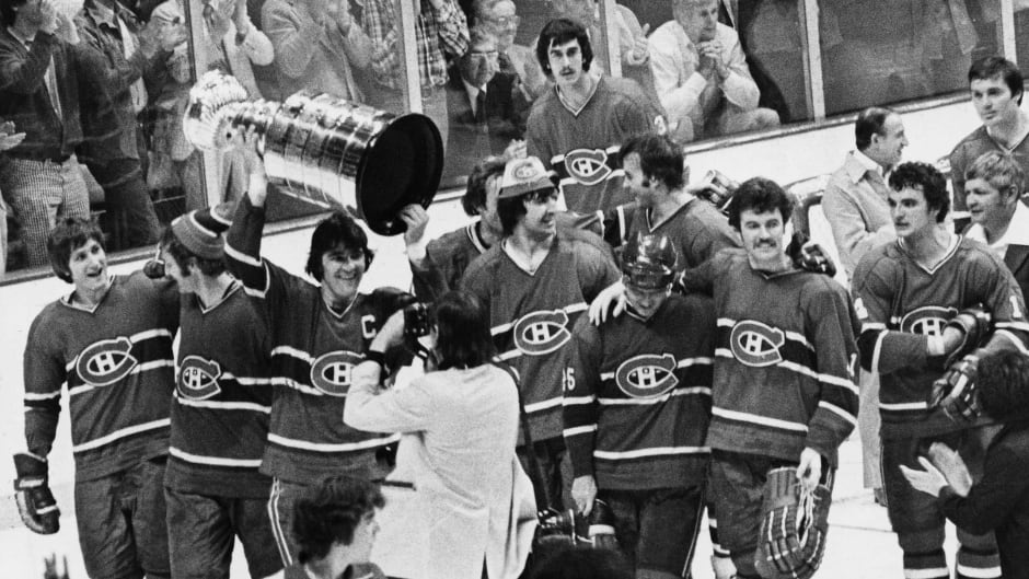 Team captain Serge Savard (holding trophy) leads the Montreal Canadiens after their 1977 Stanley Cup win in Boston, May 14, 1977.
