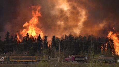 In this photograph from May 3, 2016, flames build along Highway 63 as thousands of Fort McMurray residents fled during the city-wide evacuation.<br />
Wildfire Road