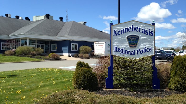 Sign in the foreground, building in the back. 