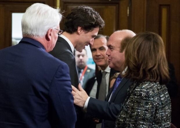 British-Canadian businessman Victor Dahdaleh greets Justin Trudeau in London